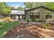 Charming home featuring a spacious backyard with a deck, patio, and lush landscaping at 4531 Kings Lake Dr, Marietta, GA 30067