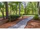 Gravel path winding through the backyard, surrounded by trees and greenery, adding charm to the landscape at 4531 Kings Lake Dr, Marietta, GA 30067
