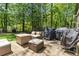 Wooden backyard deck with cushioned patio furniture, greenery, and outdoor grills perfect for entertaining at 4531 Kings Lake Dr, Marietta, GA 30067