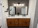Elegant bathroom featuring double sinks, granite counters, and modern light fixtures at 4531 Kings Lake Dr, Marietta, GA 30067