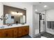 Stylish bathroom featuring a double vanity, decorative mirrors, and a glass-enclosed shower at 4531 Kings Lake Dr, Marietta, GA 30067