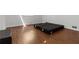A clean, minimalist bedroom is staged with warm, wood-look laminate flooring at 4531 Kings Lake Dr, Marietta, GA 30067