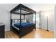 Bedroom with a dark wood four-poster bed and luxury linens at 4531 Kings Lake Dr, Marietta, GA 30067
