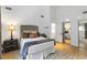 Bright bedroom features a vaulted ceiling, modern decor, a queen bed, and hardwood floors at 4531 Kings Lake Dr, Marietta, GA 30067