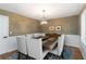 Dining room features decorative chandelier, designer wallpaper, and seating for six at 4531 Kings Lake Dr, Marietta, GA 30067
