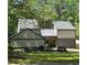 Charming home exterior with a combination of stone and siding, complemented by a well-kept lawn and mature trees at 4531 Kings Lake Dr, Marietta, GA 30067