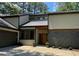 Contemporary home featuring a metal roof, a modern front door, and gray brick accents at 4531 Kings Lake Dr, Marietta, GA 30067