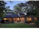 Enjoy a beautiful backyard with string lights illuminating a patio and outdoor dining area at dusk at 4531 Kings Lake Dr, Marietta, GA 30067