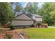 Well-maintained house has an idyllic front yard with mature landscaping and a manicured lawn at 4531 Kings Lake Dr, Marietta, GA 30067