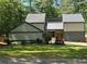 Contemporary home with modern color palette, stone accents, and lush landscaping at 4531 Kings Lake Dr, Marietta, GA 30067