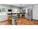 Well-lit kitchen with stainless steel appliances, white cabinets, and breakfast bar at 4531 Kings Lake Dr, Marietta, GA 30067