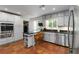Bright kitchen with breakfast bar, stainless appliances, and white cabinetry at 4531 Kings Lake Dr, Marietta, GA 30067