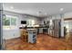 This kitchen features stainless steel appliances, painted cabinets, and a breakfast bar with terracotta floors at 4531 Kings Lake Dr, Marietta, GA 30067