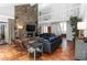 Stunning living room featuring a stone fireplace, terra cotta floors, and abundant natural light at 4531 Kings Lake Dr, Marietta, GA 30067