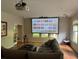 Bright living room featuring projector screen, recessed lighting, and terra-cotta tile floors at 4531 Kings Lake Dr, Marietta, GA 30067