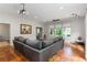 Living room with large sectional, projector, and backyard views through large windows at 4531 Kings Lake Dr, Marietta, GA 30067
