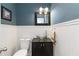Stylish powder room with a glass bowl sink and elegant wainscoting at 4531 Kings Lake Dr, Marietta, GA 30067