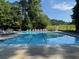 Large, clear swimming pool with lounge chairs and safety equipment for community enjoyment at 4531 Kings Lake Dr, Marietta, GA 30067