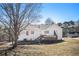 A home's exterior backyard area with a wooden deck and expansive lawn at 7760 Poppy Dr, Winston, GA 30187