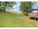 Expansive backyard featuring a lush lawn, wooden fence, and mature trees, offering privacy at 7760 Poppy Dr, Winston, GA 30187