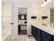 Bathroom featuring double sinks, modern fixtures, with view into Main Bedroom at 7760 Poppy Dr, Winston, GA 30187