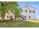 Charming two-story home with a large front yard and stairs leading to the entrance at 7760 Poppy Dr, Winston, GA 30187