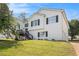 Charming two-story home with a large front yard, stairs leading to the entrance and traditional black shutters at 7760 Poppy Dr, Winston, GA 30187