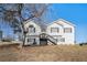 Charming two-story home with a well-maintained lawn and a classic design and front stairs to entrance at 7760 Poppy Dr, Winston, GA 30187