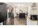 Bright kitchen and dining area with stainless steel refrigerator and modern flooring at 7760 Poppy Dr, Winston, GA 30187