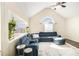 Bright living room with vaulted ceilings, large windows, and comfortable blue sectional sofa at 7760 Poppy Dr, Winston, GA 30187