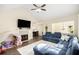 Comfortable living room with modern fireplace and tv on wall and open plan dining area at 7760 Poppy Dr, Winston, GA 30187
