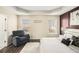 Comfortable main bedroom with an accent wall, modern decor, and sitting area at 7760 Poppy Dr, Winston, GA 30187