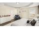 Bright main bedroom with a dresser, large windows, and a doorway to an ensuite bathroom at 7760 Poppy Dr, Winston, GA 30187