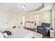 Main bedroom with a reading chair, large windows, and a doorway to an ensuite bathroom at 7760 Poppy Dr, Winston, GA 30187