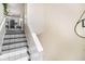 Unique staircase with custom-designed tiling and white risers and banisters at 7760 Poppy Dr, Winston, GA 30187
