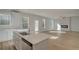 Contemporary kitchen featuring an island with sink and adjacent open floorplan with modern fireplace at 101 Belvedere Rd, Mcdonough, GA 30253