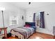 Bedroom featuring hardwood floors, a window providing natural light, and basic furnishings at 1081 Longley Nw Ave, Atlanta, GA 30318