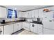 Functional kitchen with white cabinets and appliances, maximizing space with simple design at 1081 Longley Nw Ave, Atlanta, GA 30318