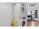 Convenient laundry area with stacked washer and dryer units next to bedroom at 1081 Longley Nw Ave, Atlanta, GA 30318