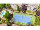 Aerial view of community tennis court and swimming pool surrounded by beautiful landscaping at 1250 Parkwood Se Cir # 1203, Atlanta, GA 30339