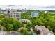 Scenic aerial view of a property nestled among lush trees with modern buildings in the background at 1250 Parkwood Se Cir # 1203, Atlanta, GA 30339