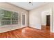 Bedroom featuring a bright window with a door to the outside and hardwood floors offering a blend of comfort and style at 1250 Parkwood Se Cir # 1203, Atlanta, GA 30339