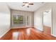 Bright bedroom featuring a ceiling fan and ample natural light streaming through the large window and access to the outside at 1250 Parkwood Se Cir # 1203, Atlanta, GA 30339