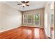 Bedroom with hardwood floors, ceiling fan, large window and balcony access at 1250 Parkwood Se Cir # 1203, Atlanta, GA 30339