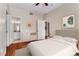 Inviting bedroom with neutral tones, showcasing a bed, a dresser, and a view into an ensuite bathroom at 1250 Parkwood Se Cir # 1203, Atlanta, GA 30339