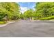 Gated community entrance with brick pillars, manicured landscaping, and secure access for residents at 1250 Parkwood Se Cir # 1203, Atlanta, GA 30339