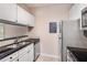 Functional kitchen featuring stainless steel appliances, sleek black countertops, and crisp white cabinetry at 1250 Parkwood Se Cir # 1203, Atlanta, GA 30339