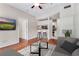 Open-concept living space includes bar seating and hardwood floors, complemented by a view into the modern kitchen at 1250 Parkwood Se Cir # 1203, Atlanta, GA 30339