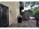 Cozy back deck with grill, chairs, and view of the trees at 249 Sycamore Pl, Decatur, GA 30030