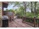 Back deck with trees and foliage, outdoor dining area, and outdoor kitchen at 249 Sycamore Pl, Decatur, GA 30030